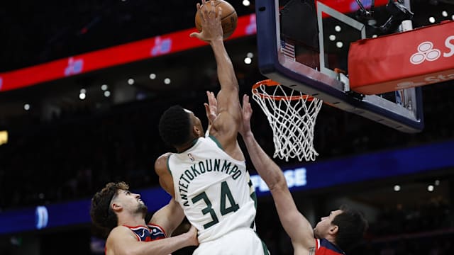 Milwaukee Bucks forward Giannis Antetokounmpo (34) dunks the ball over Washington Wizards forward Danilo Gallinari (88) and Wizards forward Deni Avdija (8)
